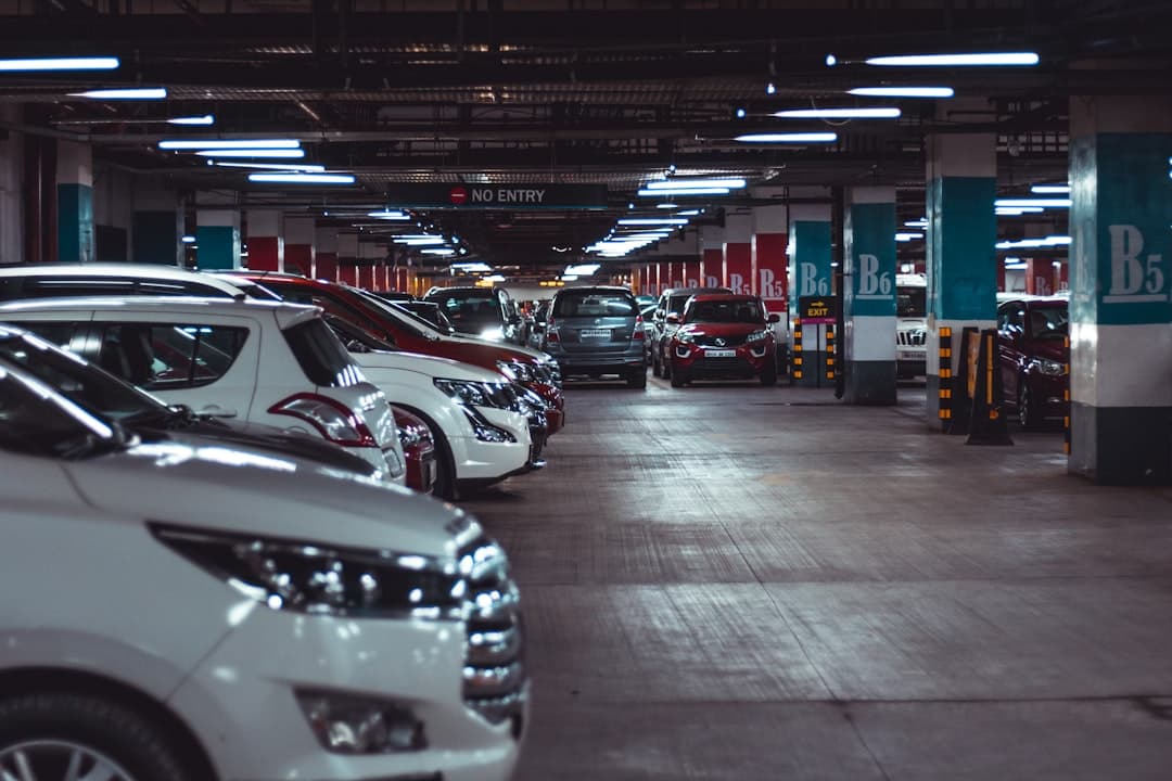 different vehicles parking on garage area of the building — Photo by Aditya Rathod on Unsplash