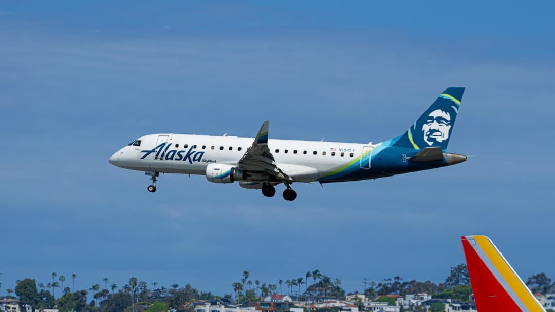 Alaska airlines jetliner descending against a blue sky. — Photo by Alito McBean on Unsplash