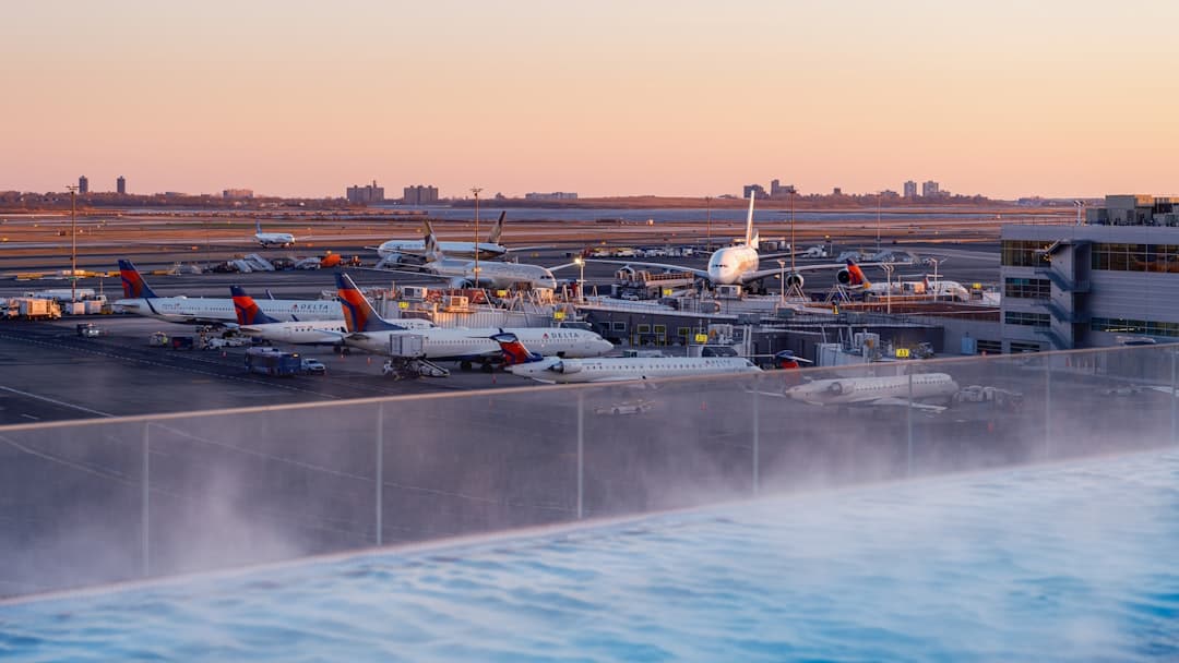 Airplanes parked at airport gates during sunset — Photo by Lumin Osity on Unsplash
