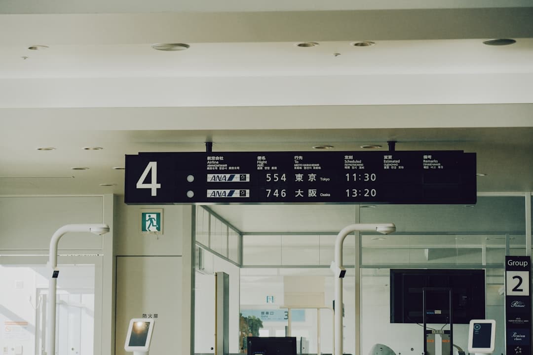 Airport departure board with flight information — Photo by Cuvii on Unsplash