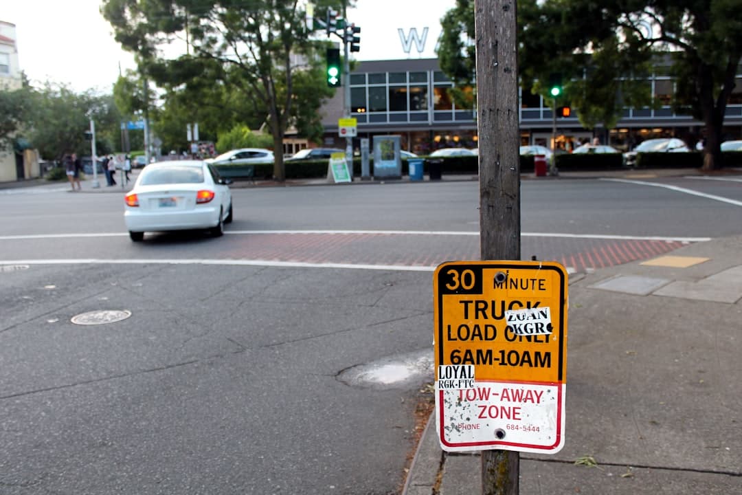 a sign on a pole — Photo by Elizabeth Woolner on Unsplash