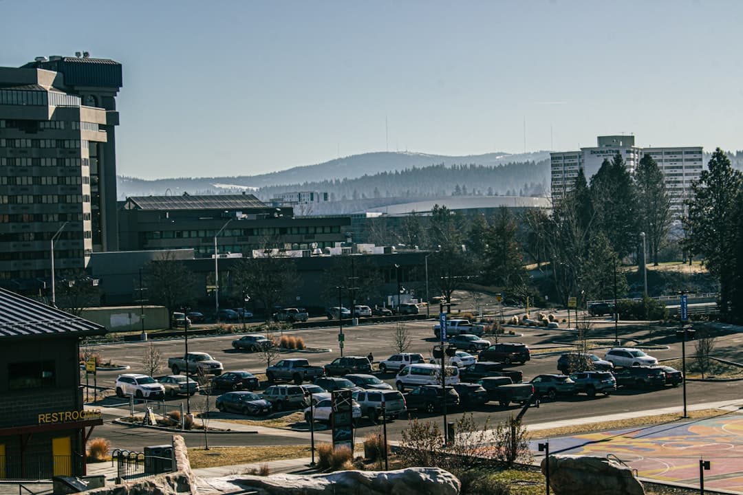Cars parked outside of a city with mountains. — Photo by Peter Robbins on Unsplash
