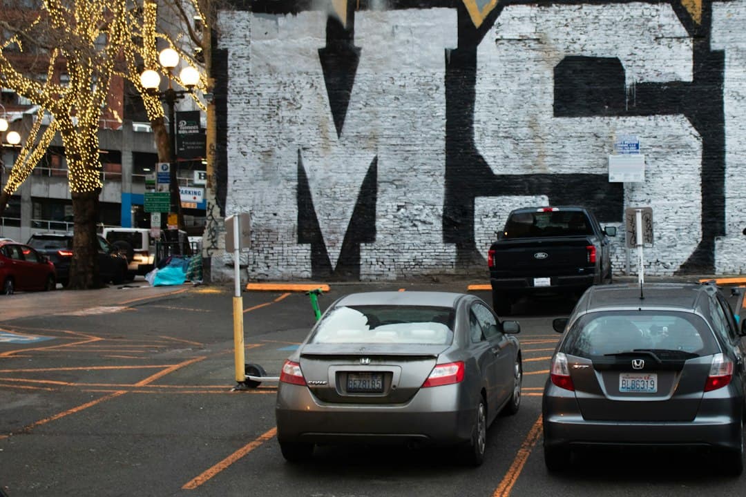 Cars are parked in a city parking lot — Photo by Zoshua Colah on Unsplash