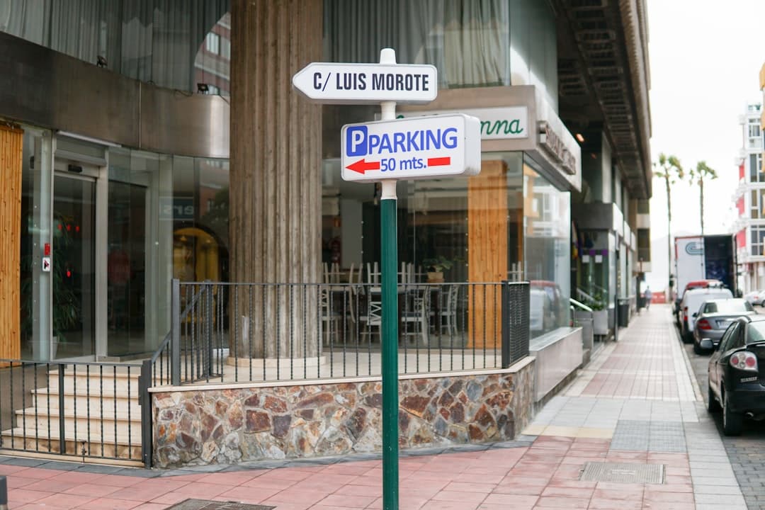 a parking sign on the side of a street — Photo by Liga Brolisa on Unsplash