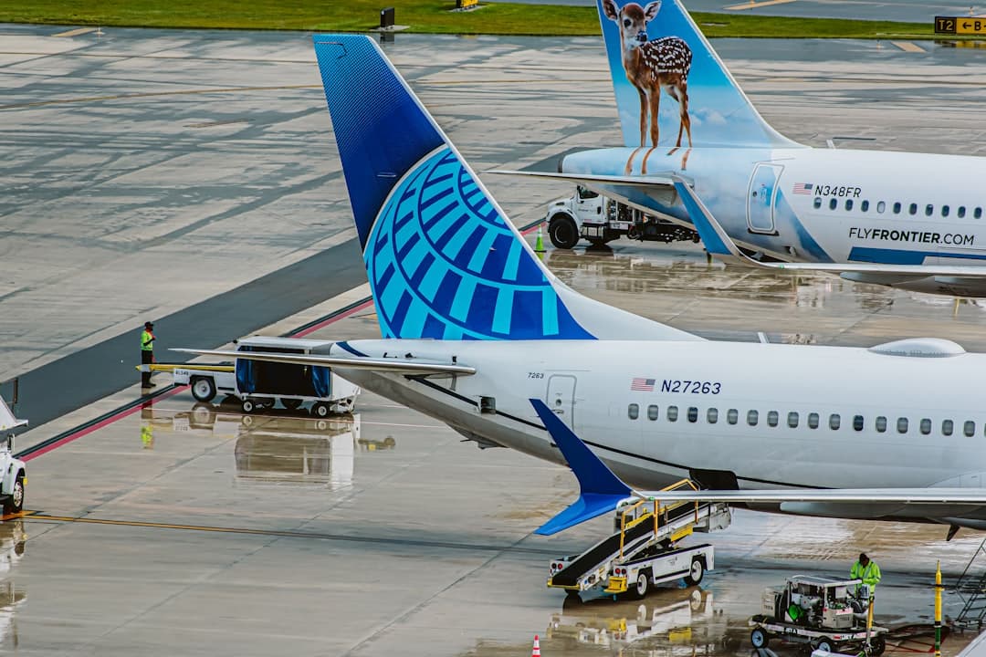 a couple of large airplanes at an airport — Photo by Lukas Souza on Unsplash