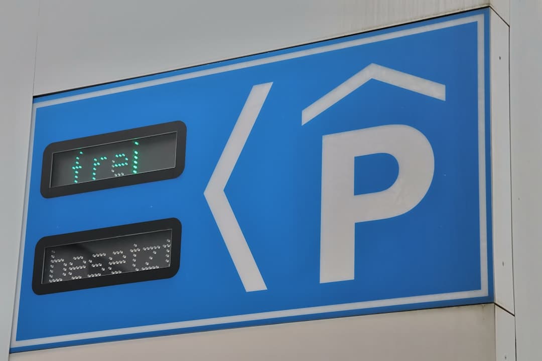 A blue parking sign with a clock on it — Photo by Andrey Larionov on Unsplash
