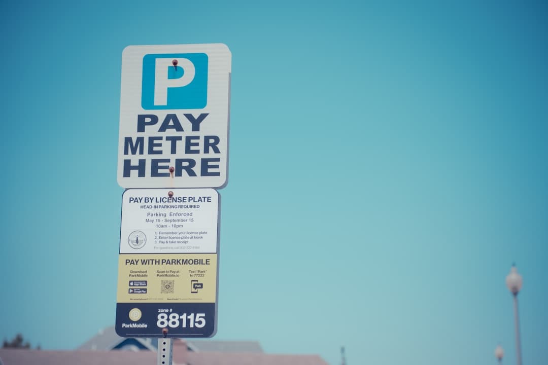 A pay meter here sign in front of a building — Photo by Magic Fan on Unsplash