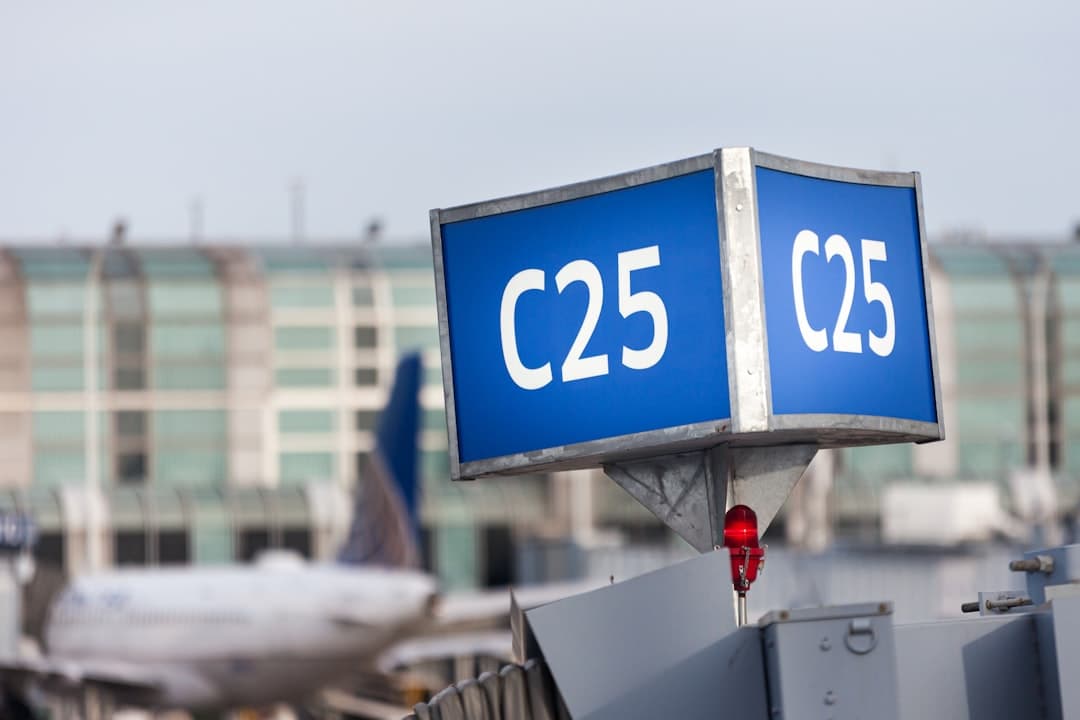 a large blue sign sitting on top of an airport tarmac — Photo by Rafik Wahba on Unsplash