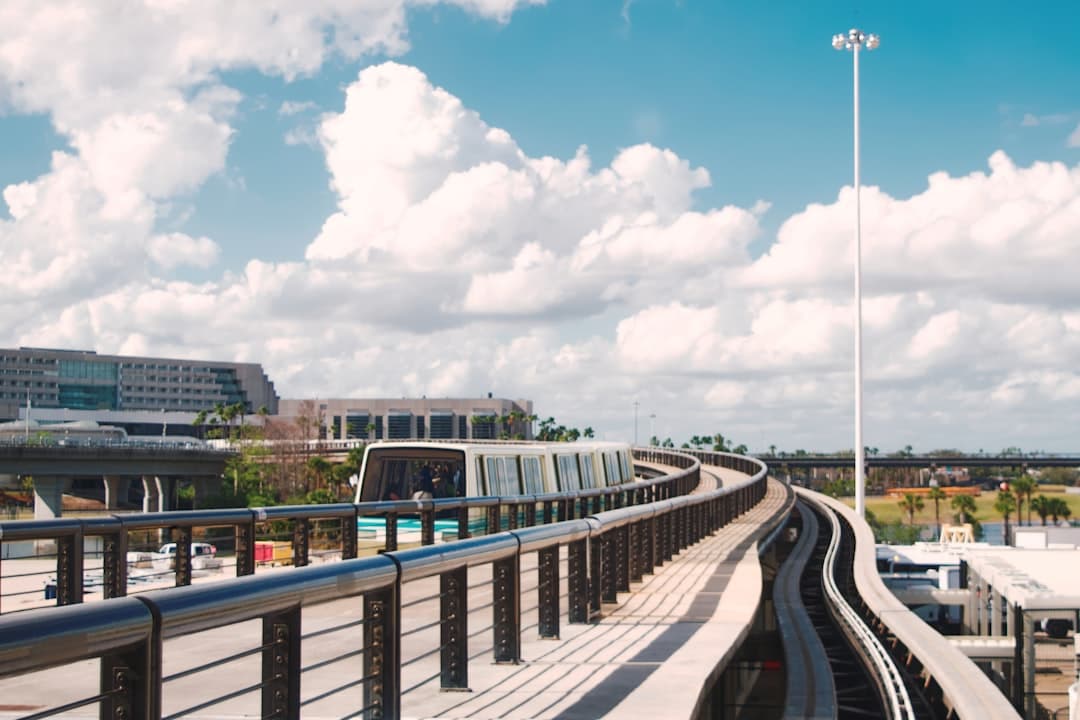 Automated train on elevated tracks with modern buildings. — Photo by Jonathan Marchant on Unsplash