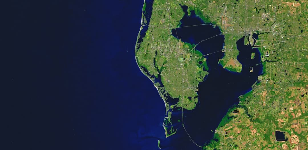 Aerial view of a coastline with a large bay. — Photo by USGS on Unsplash