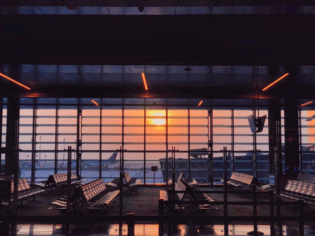 the sun is setting through the window of an airport — Photo by Safwan Mahmud on Unsplash