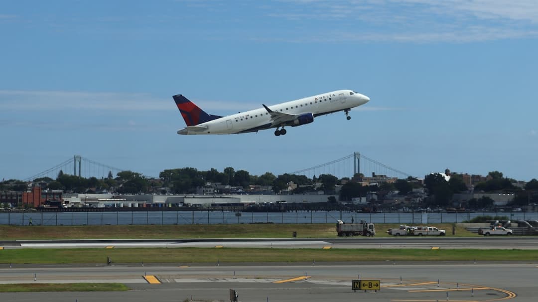 Airplane taking off with a city skyline background. — Photo by Structural Photography on Unsplash