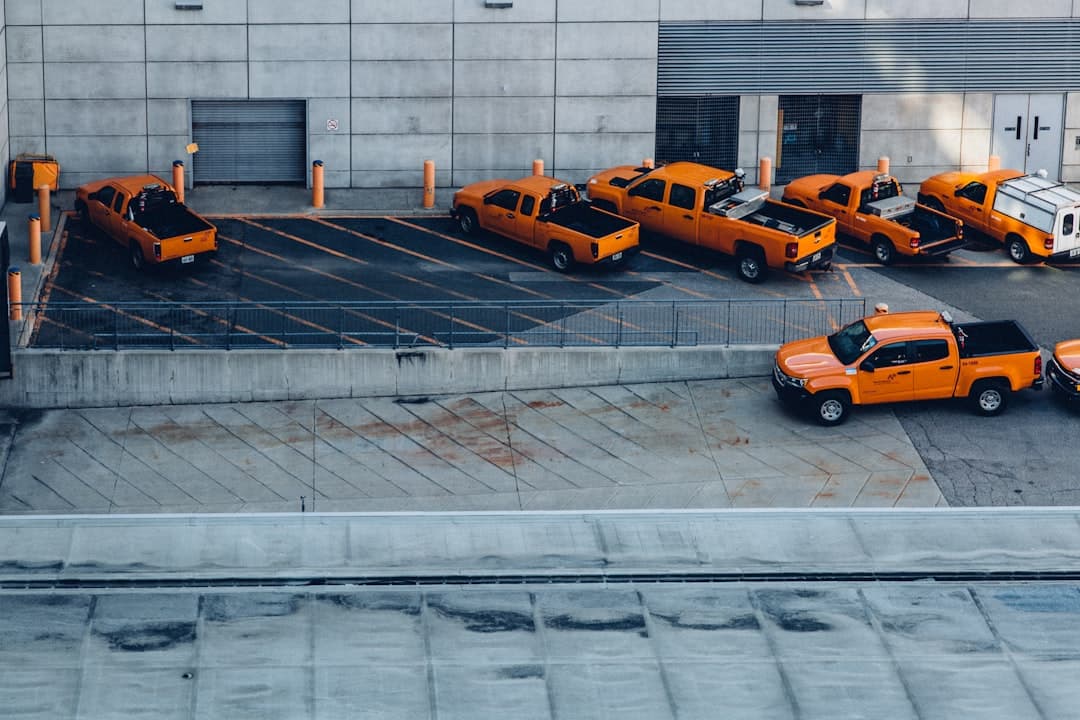 orange pickup trucks on parking lot — Photo by Zoran Zonde Stojanovski on Unsplash