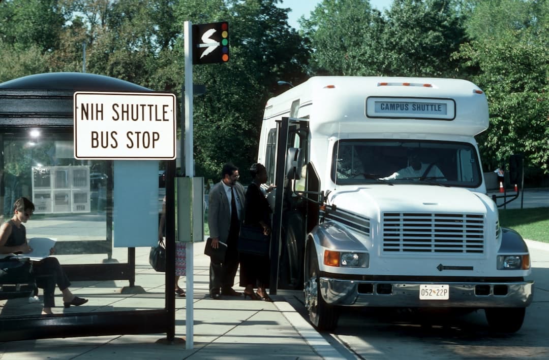 white and black bus on road during daytime — Photo by National Cancer Institute on Unsplash
