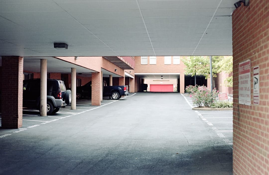 an empty parking lot with cars parked in it — Photo by Mark Stenglein on Unsplash