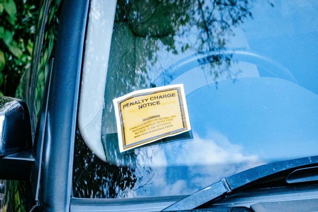 a car with a yellow sign attached to it's side window — Photo by Samuel Regan-Asante on Unsplash