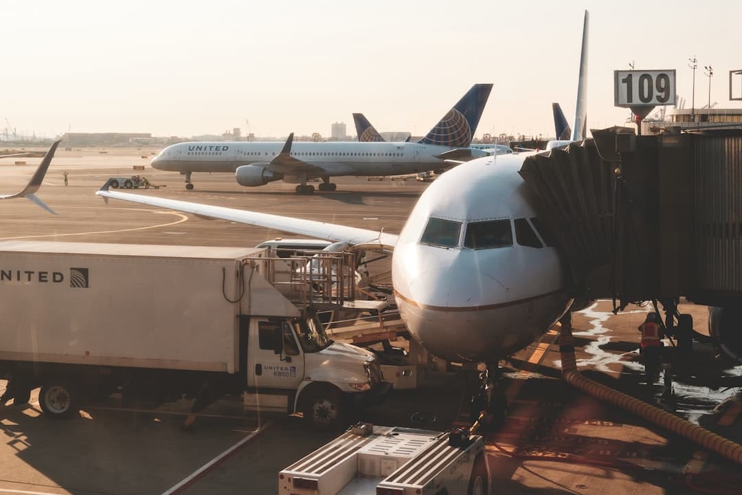white airplanes at airport during daytime — Photo by Christian Lambert on Unsplash