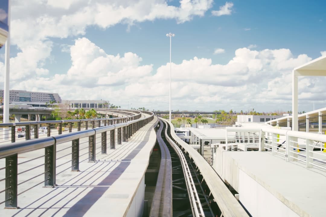 Automated train tracks curve through a modern airport. — Photo by Jonathan Marchant on Unsplash
