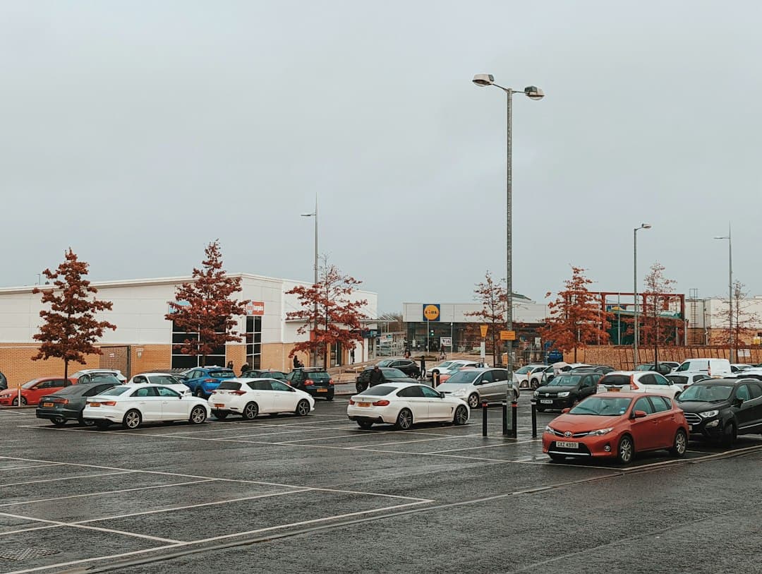 a parking lot filled with lots of parked cars — Photo by Nick Nice on Unsplash