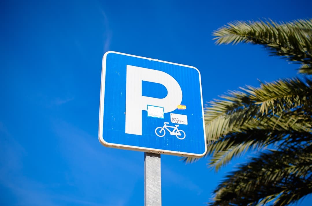a blue parking sign with a bicycle on it — Photo by Anastasiia Shyrokykh on Unsplash
