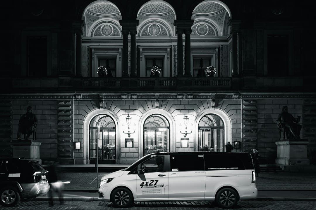 a white van parked in front of a building — Photo by Poul Hoang on Unsplash
