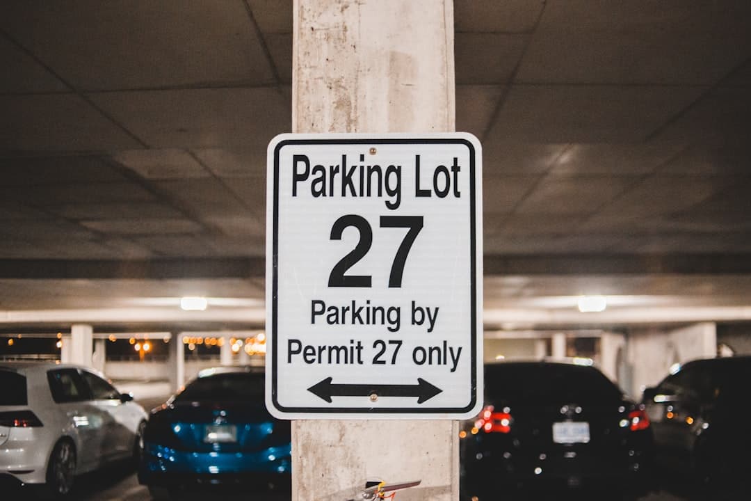 white and black no parking no parking sign — Photo by Erik Mclean on Unsplash