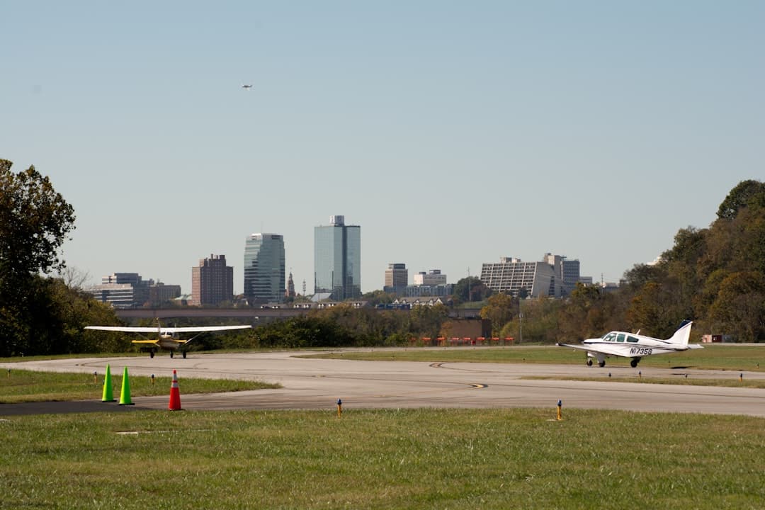 Planes prepare for takeoff with a city skyline. — Photo by joseph linnik on Unsplash