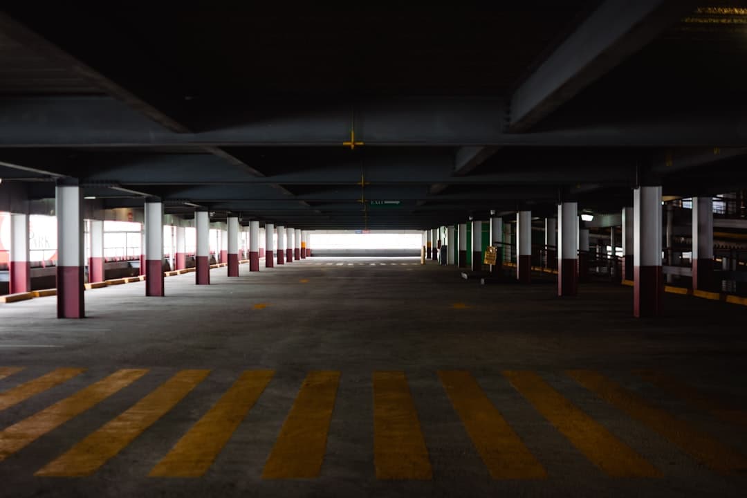 An empty parking garage with yellow and white stripes — Photo by Ruona Gbinije on Unsplash