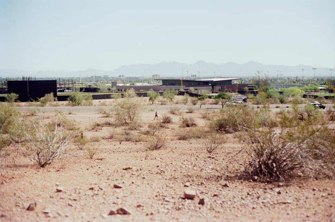 Desert landscape with buildings in the background — Photo by Abhinav Gorantla on Unsplash