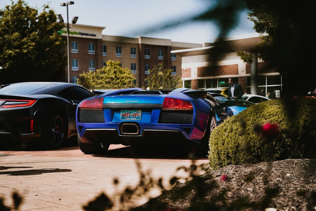a couple of sports cars parked next to each other — Photo by Nate Dieckhaus on Unsplash