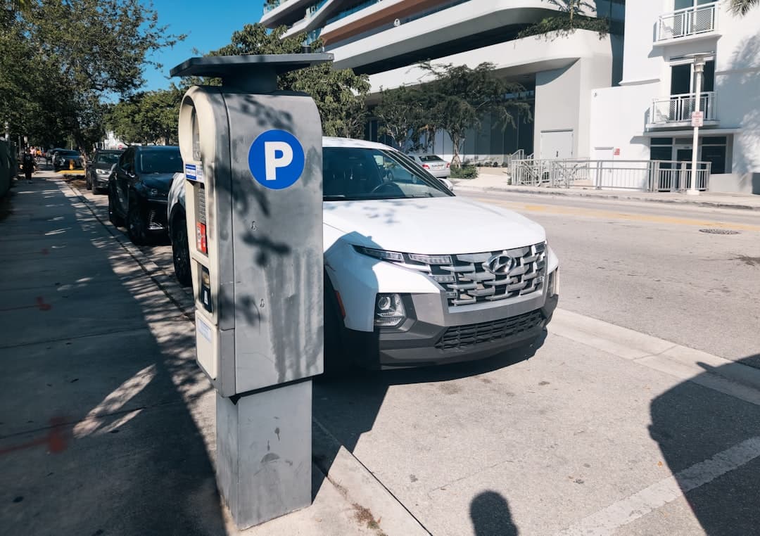 A car parked on the side of a street next to a parking meter — Photo by Zoshua Colah on Unsplash