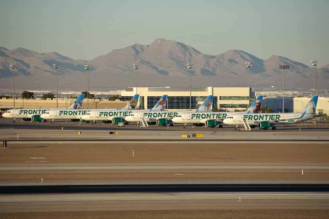 A group of planes parked at an airport — Photo by David Syphers on Unsplash