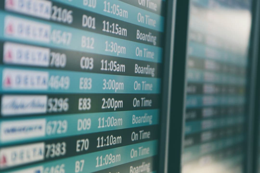 Airport departures timetable showing Delta and Alaska Airlines flights on time and boarding — Photo by Matthew Smith on Unsplash