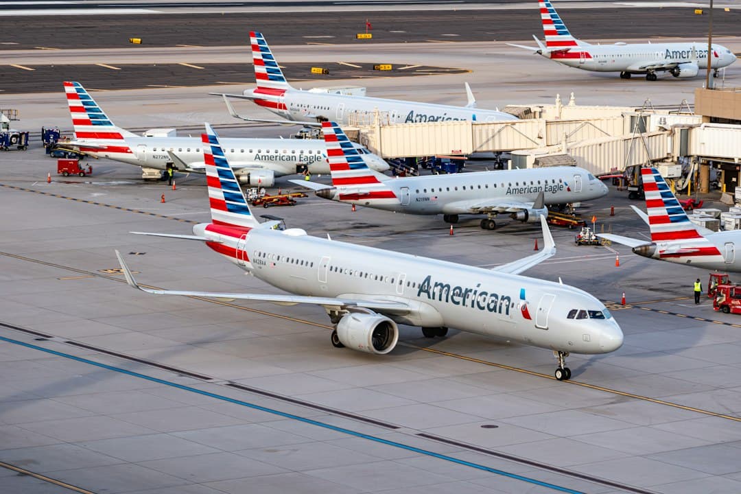A group of american airlines planes parked at an airport — Photo by Jake Hough on Unsplash