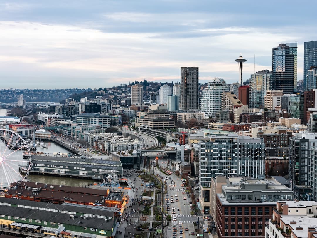 Seattle skyline with waterfront and space needle visible — Photo by Josh Hild on Unsplash