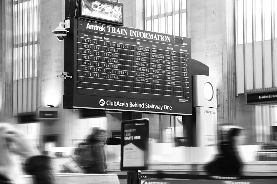 grayscale photo of a man in black jacket standing in front of a store — Photo by Elijah Chen on Unsplash