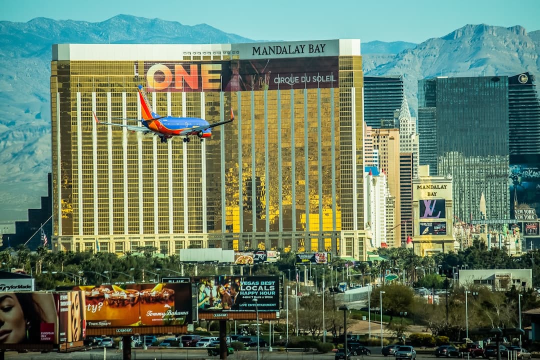 red and white airplane on mid air near city buildings during daytime — Photo by Marly Mele on Unsplash