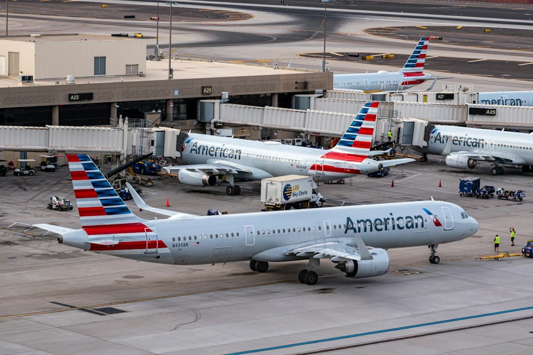 A group of american airlines planes parked at an airport — Photo by Jake Hough on Unsplash