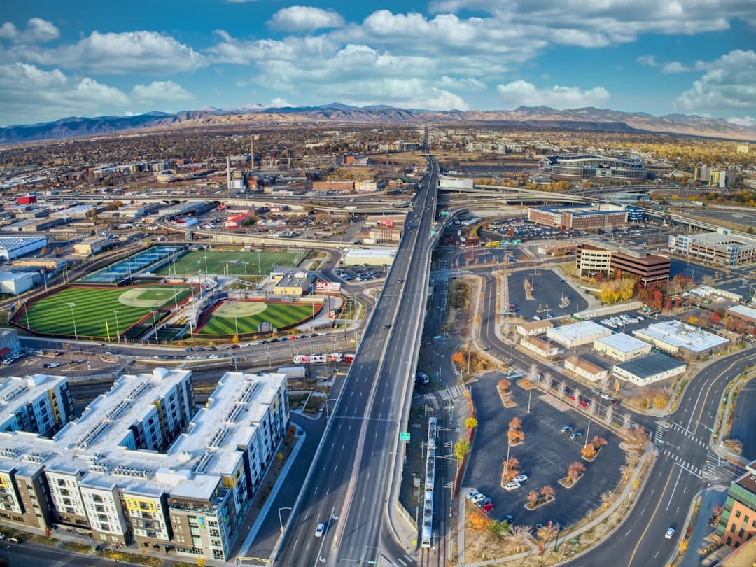 an aerial view of a city with a baseball field — Photo by Acton Crawford on Unsplash