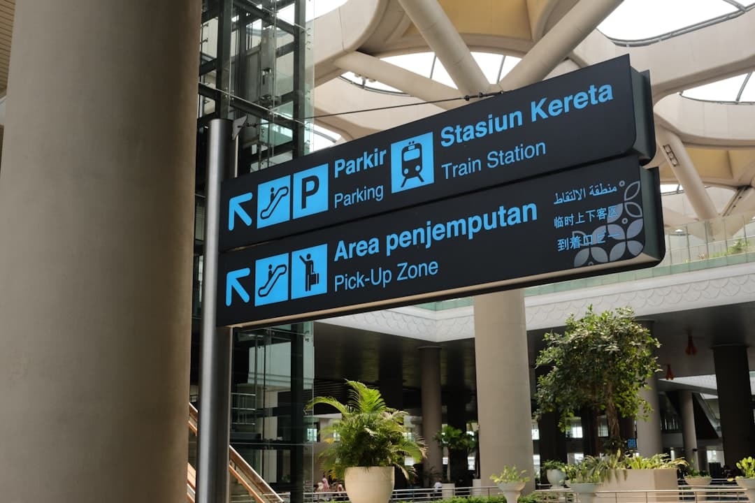 A large building with a bunch of signs hanging from it's ceiling — Photo by Rudityas W Anggoro on Unsplash