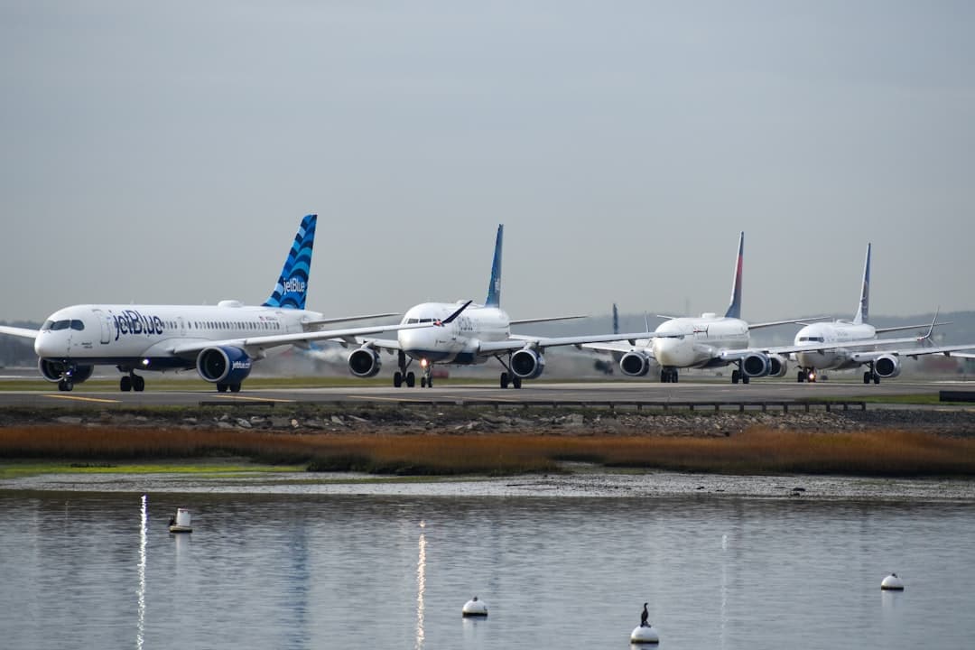 A row of airplanes sitting on top of an airport runway — Photo by David Syphers on Unsplash