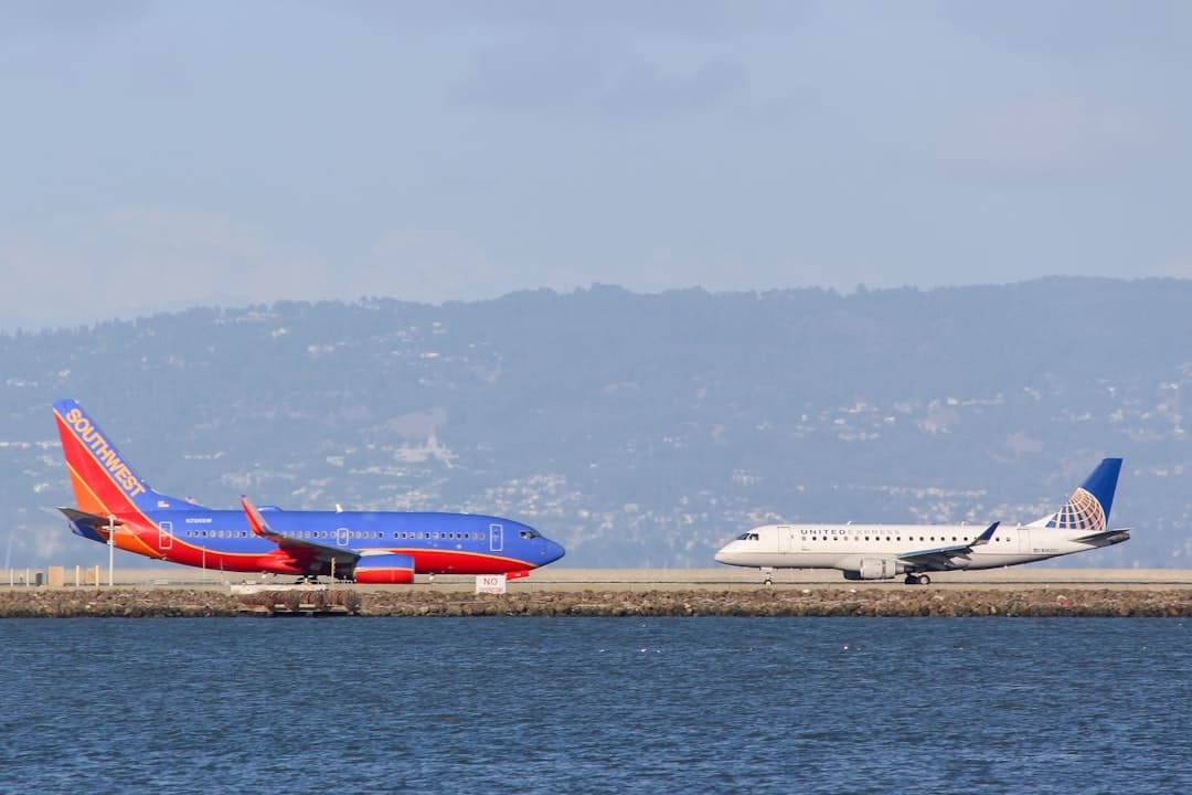 white and blue passenger plane on airport during daytime — Photo by Justin Hu on Unsplash