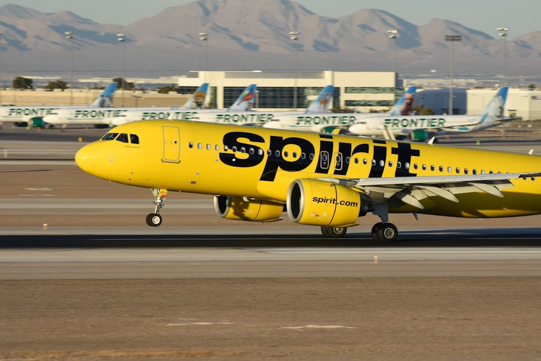A yellow spirit airplane on the runway of an airport — Photo by David Syphers on Unsplash
