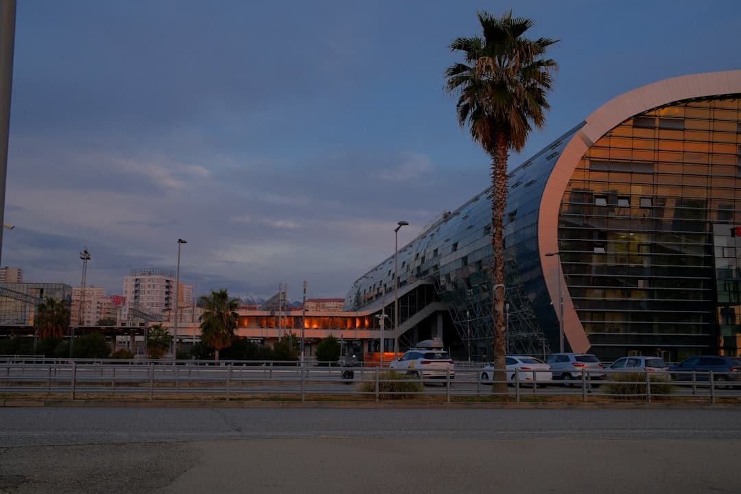 Modern building with palm tree at dusk — Photo by Sergei CH on Unsplash