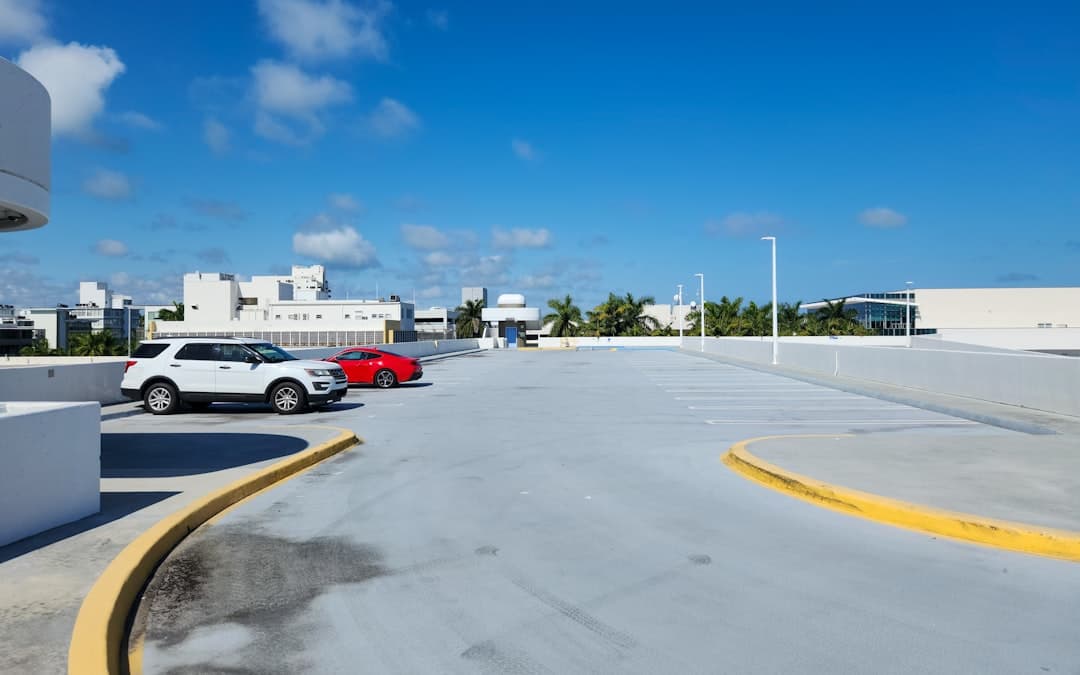 A parking lot with cars parked in it — Photo by Zoshua Colah on Unsplash