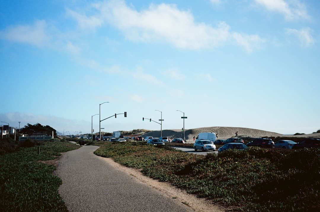 cars parked on parking lot under blue sky during daytime — Photo by William Hsu on Unsplash