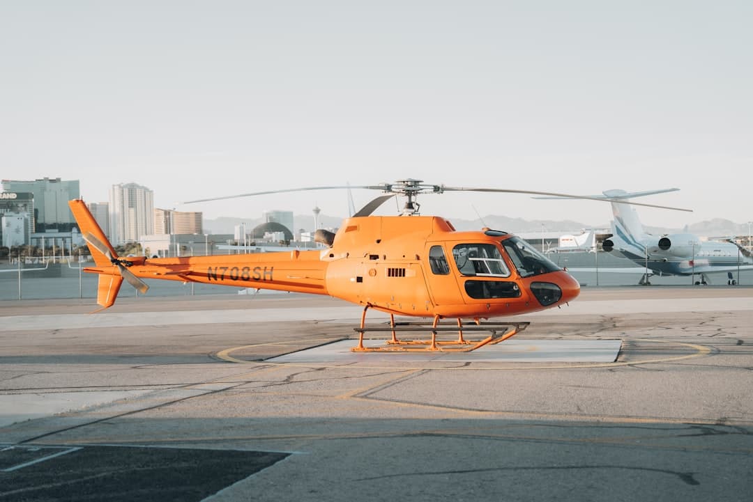 a helicopter sits on the tarmac of an airport — Photo by Nejc Soklič on Unsplash