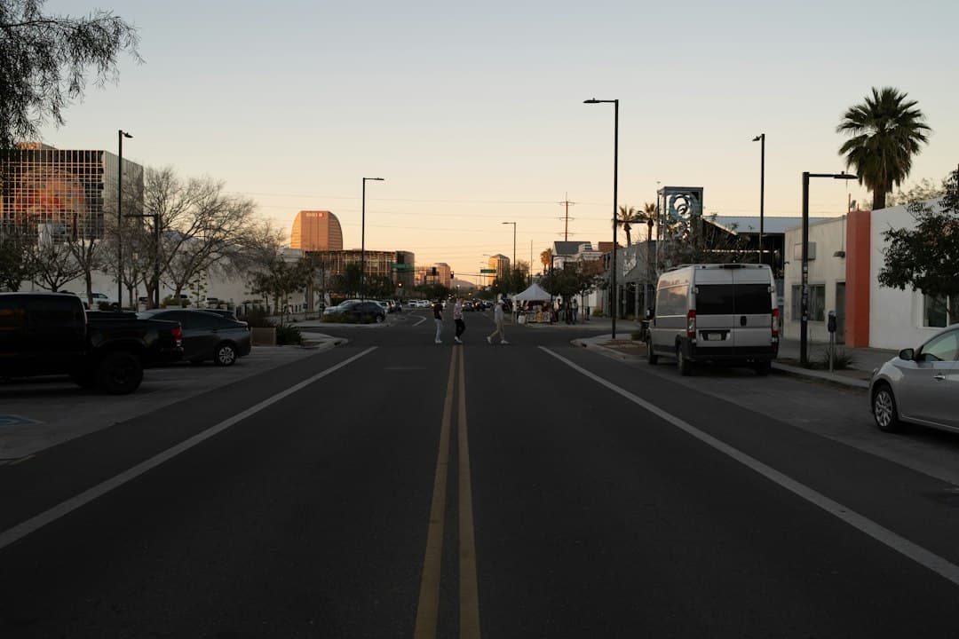a street lined with parked cars and palm trees — Photo by PJ Gal-Szabo on Unsplash