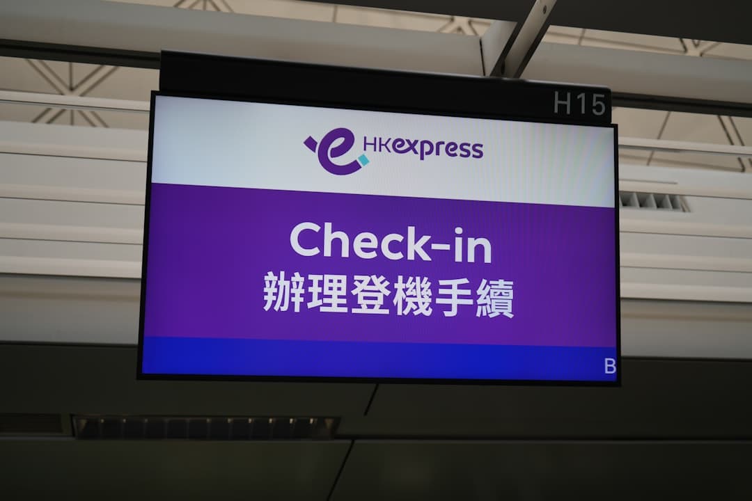 a sign that says check - in in in an airport — Photo by Ivan Lau on Unsplash