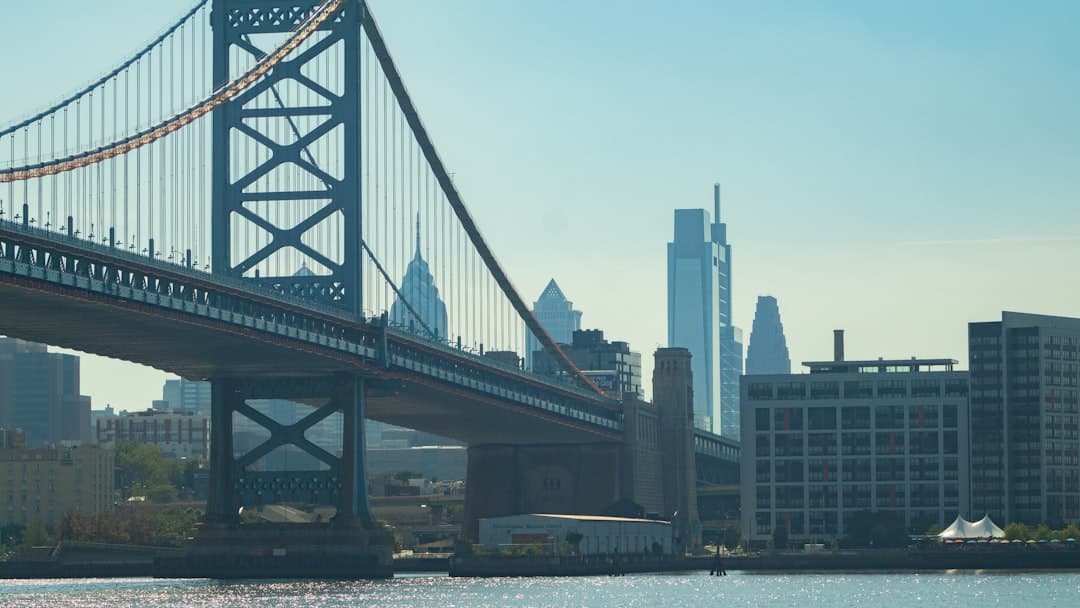 a bridge over water with buildings in the background — Photo by Donte Brown on Unsplash